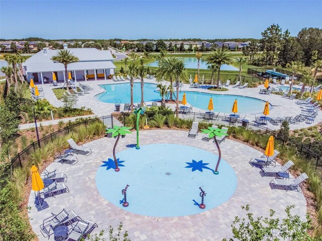 view of swimming pool featuring a water view and a patio