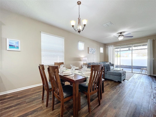 dining room with a textured ceiling, dark hardwood / wood-style floors, and ceiling fan with notable chandelier