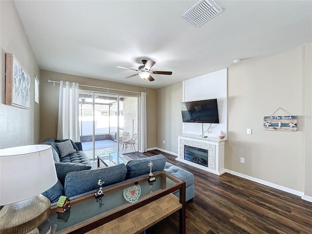 living room with dark hardwood / wood-style floors and ceiling fan