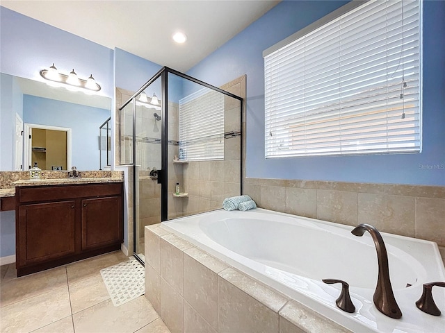 bathroom with plus walk in shower, vanity, and tile patterned floors