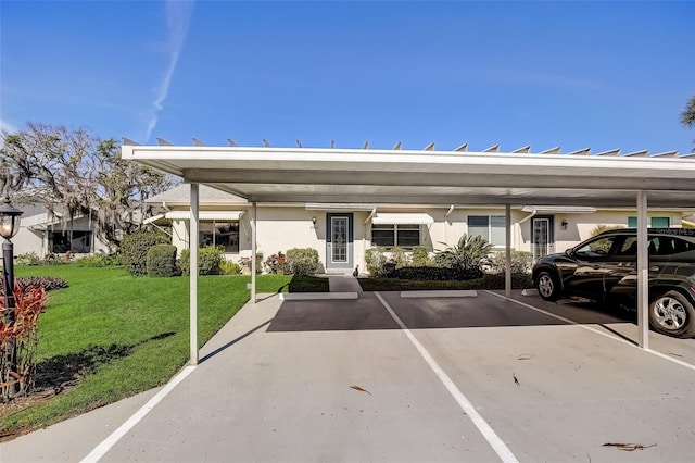 view of car parking featuring a carport and a lawn