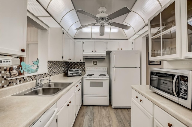 kitchen featuring white cabinets, white appliances, under cabinet range hood, and light countertops