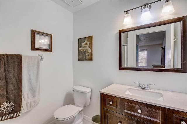 bathroom featuring toilet and vanity