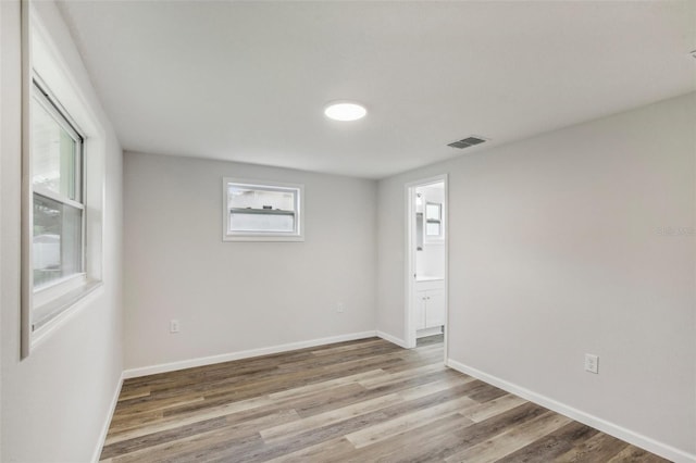 empty room with hardwood / wood-style floors