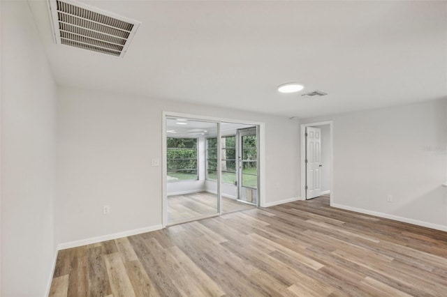 unfurnished room with wood-type flooring