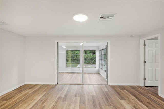 unfurnished room featuring hardwood / wood-style floors