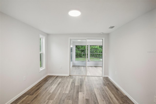 unfurnished room featuring hardwood / wood-style flooring