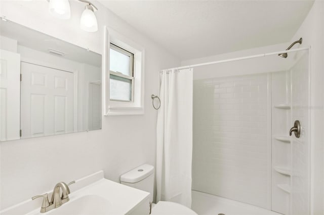 bathroom with sink, toilet, and a shower with curtain