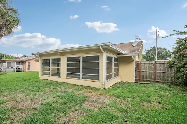 back of house with a yard