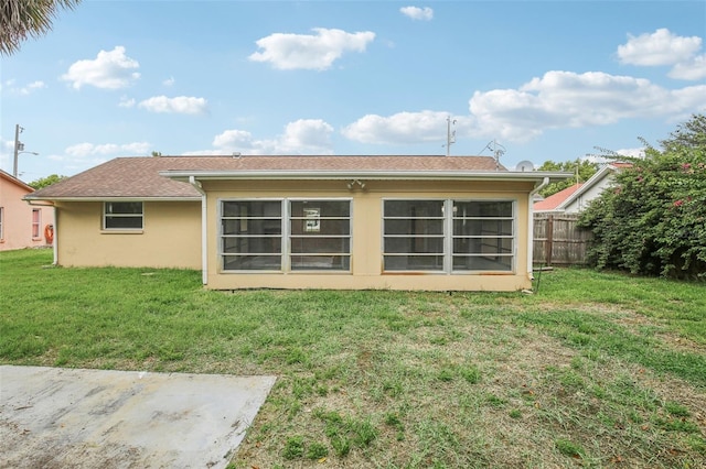 back of house with a lawn