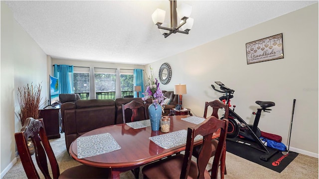 dining area featuring carpet floors, a textured ceiling, and a chandelier