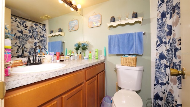 bathroom with toilet and vanity