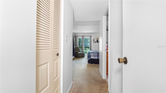 hall with a textured ceiling