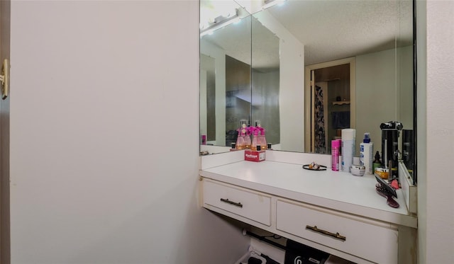 bathroom featuring vanity and a textured ceiling