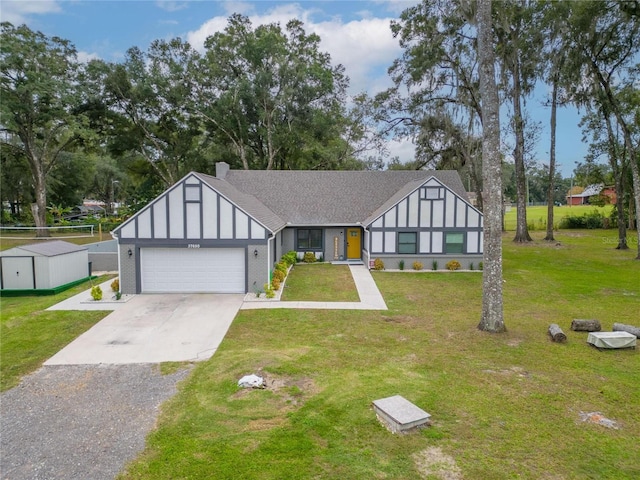 view of front of property with a garage and a front lawn