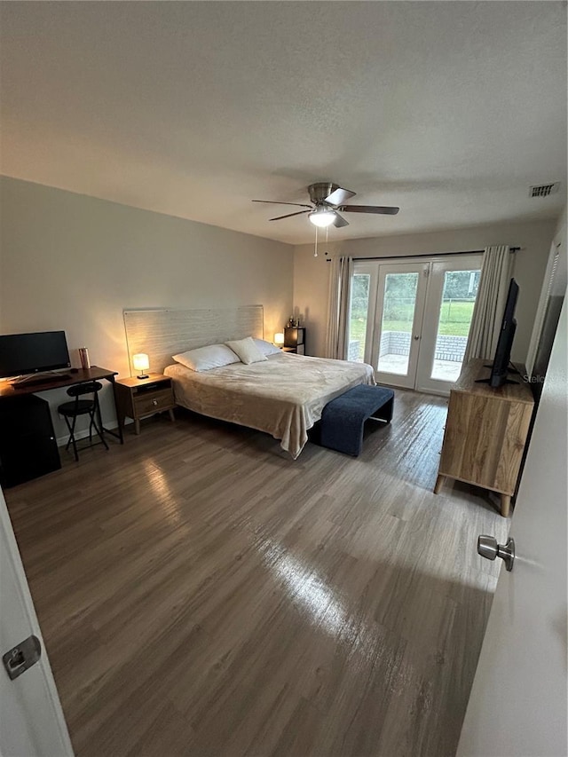 bedroom featuring dark hardwood / wood-style flooring, a textured ceiling, ceiling fan, french doors, and access to outside