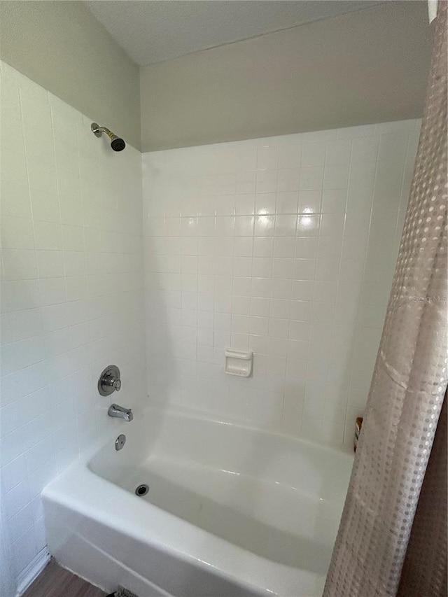 bathroom featuring shower / bathtub combination with curtain