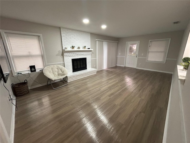 unfurnished living room with a fireplace and dark hardwood / wood-style flooring