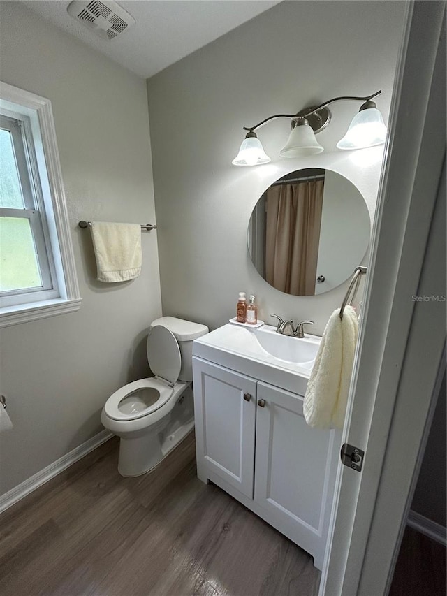 bathroom featuring hardwood / wood-style flooring, vanity, and toilet