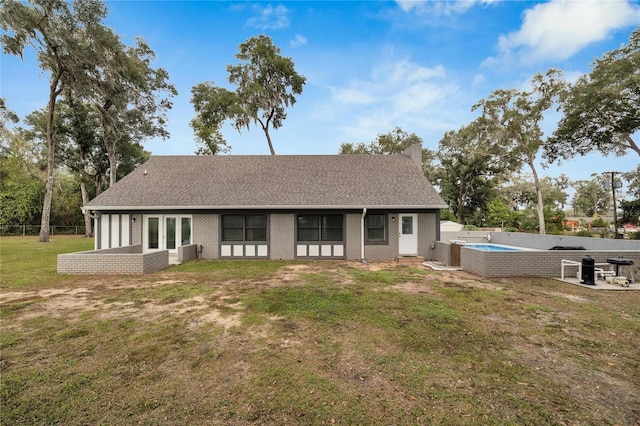 back of property with a lawn and central AC