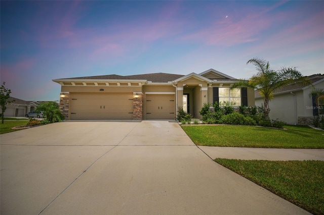 view of front facade featuring a garage and a yard