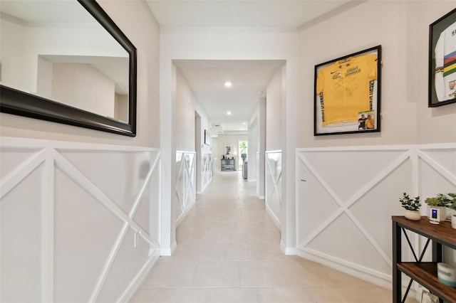 hall featuring light tile patterned floors