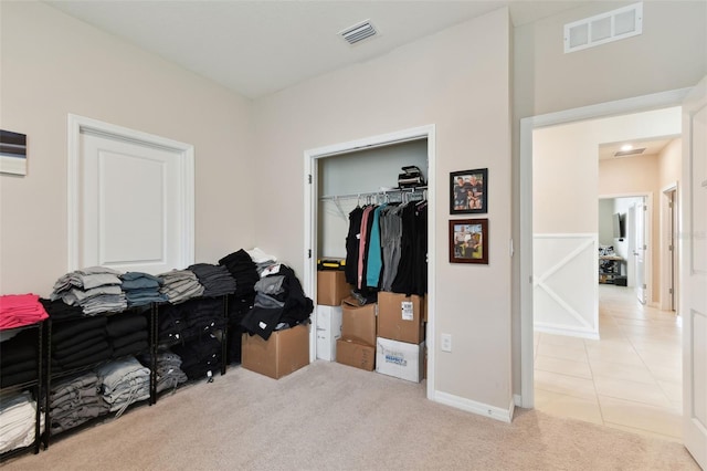 bedroom with light carpet and a closet