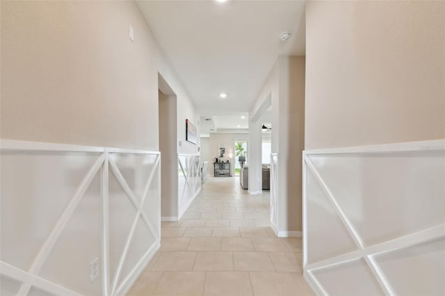 hall with light tile patterned floors