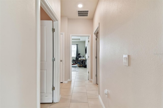 hallway featuring light tile patterned flooring