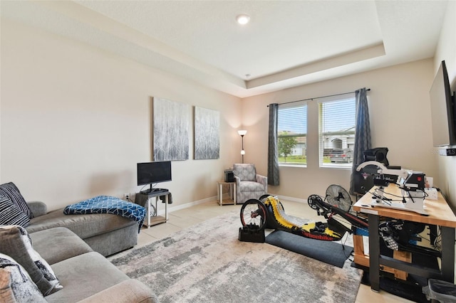 interior space with light tile patterned floors and a raised ceiling