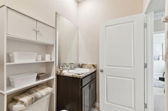 bathroom with toilet and vanity