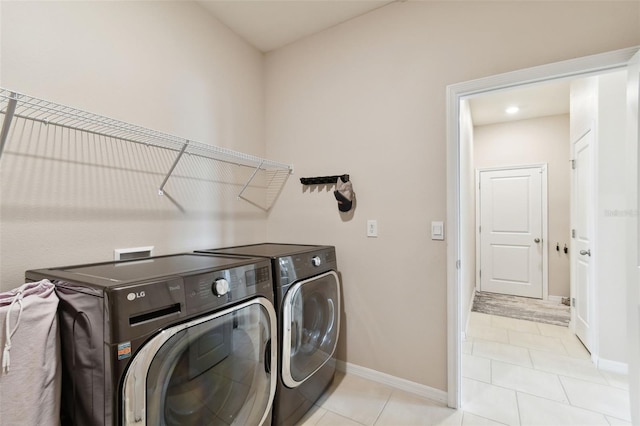 laundry area featuring separate washer and dryer and light tile patterned floors