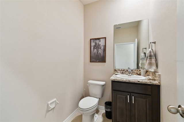 bathroom with vanity, toilet, and tile patterned floors