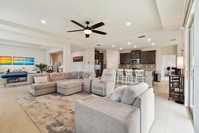 living room featuring light tile patterned flooring and ceiling fan