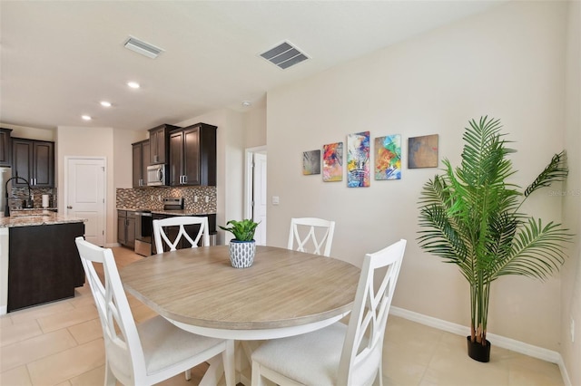 tiled dining space featuring sink