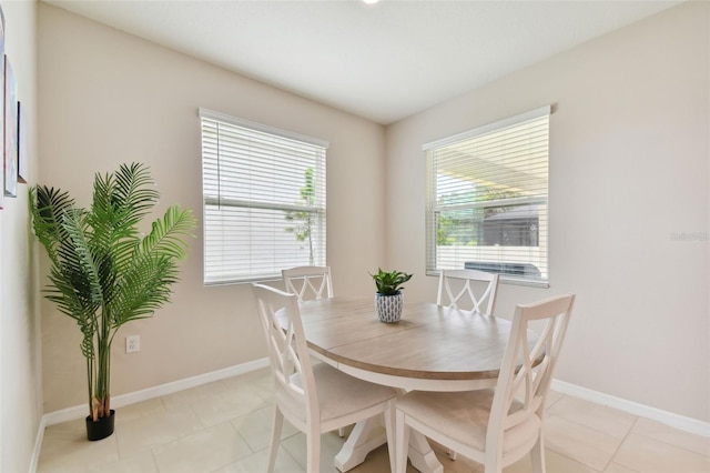 dining room with a wealth of natural light and light tile patterned floors