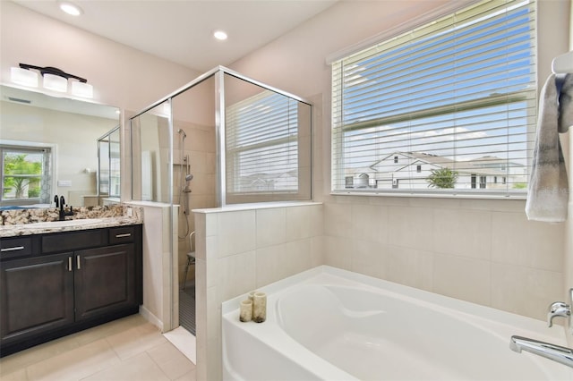 bathroom featuring vanity, tile patterned flooring, and separate shower and tub