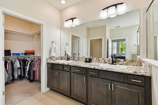 bathroom featuring tile patterned floors and double sink vanity