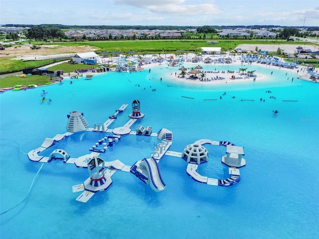 drone / aerial view with a water view and a beach view