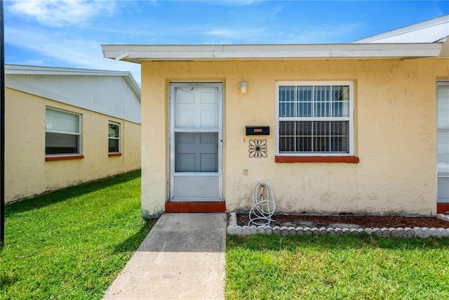 property entrance with a yard