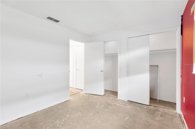 unfurnished bedroom featuring multiple closets