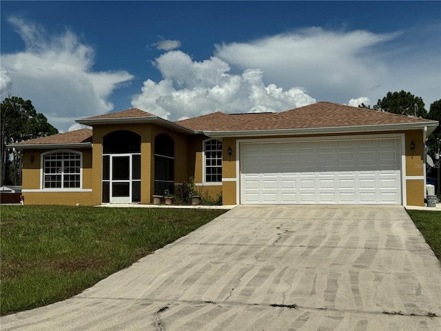 view of front of property with a garage and a front lawn