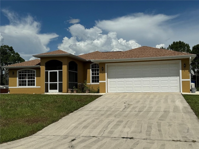 view of front of house featuring a garage and a front lawn