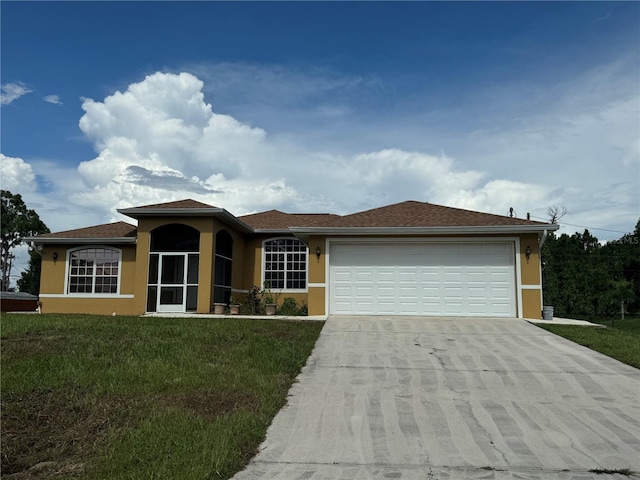 view of front of home with a garage and a front lawn