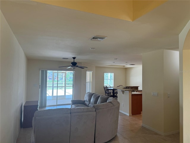 living room featuring ceiling fan and light tile patterned floors