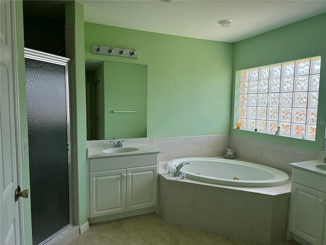 bathroom featuring vanity, independent shower and bath, and tile patterned floors