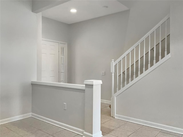 stairs featuring tile patterned floors