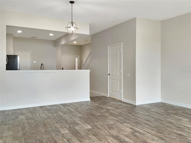 unfurnished room with sink and hardwood / wood-style flooring