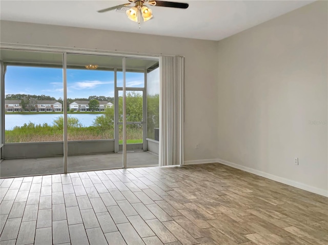 empty room with ceiling fan, light hardwood / wood-style floors, and plenty of natural light