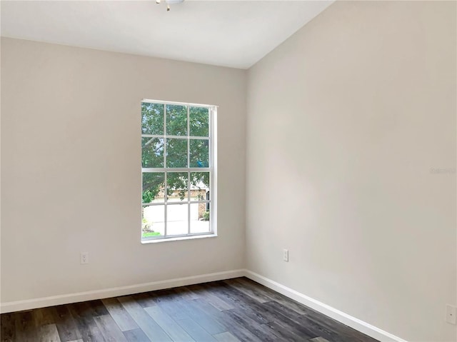 empty room with dark hardwood / wood-style flooring